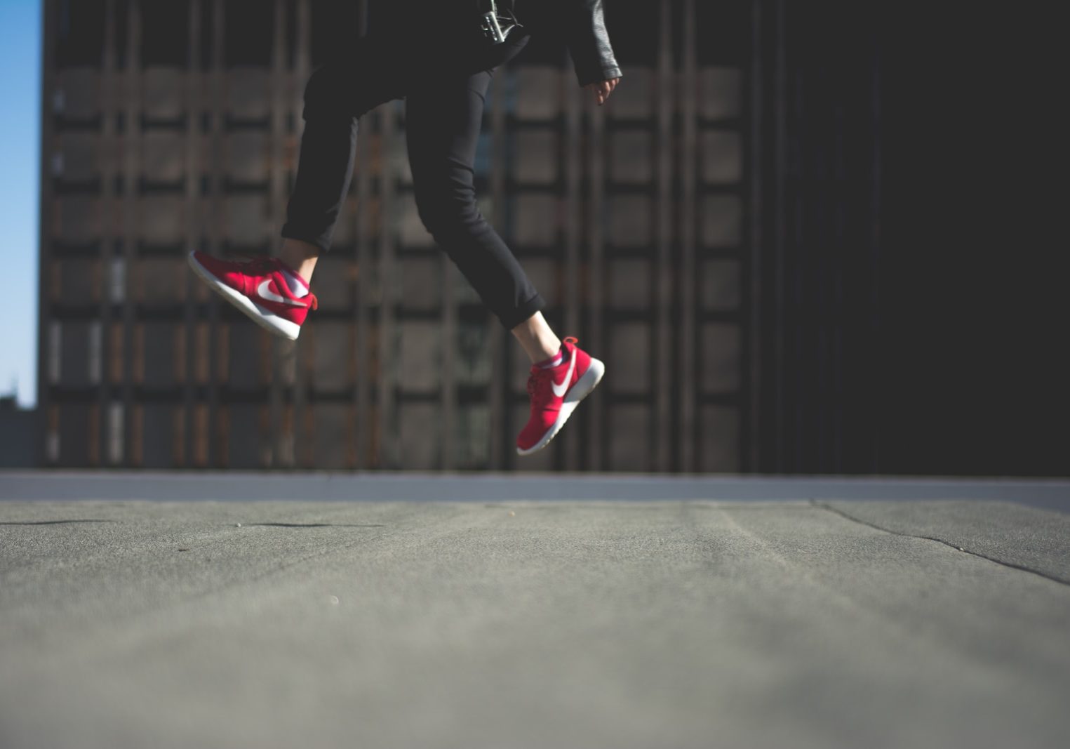 person wearing pair of red Nike shoes