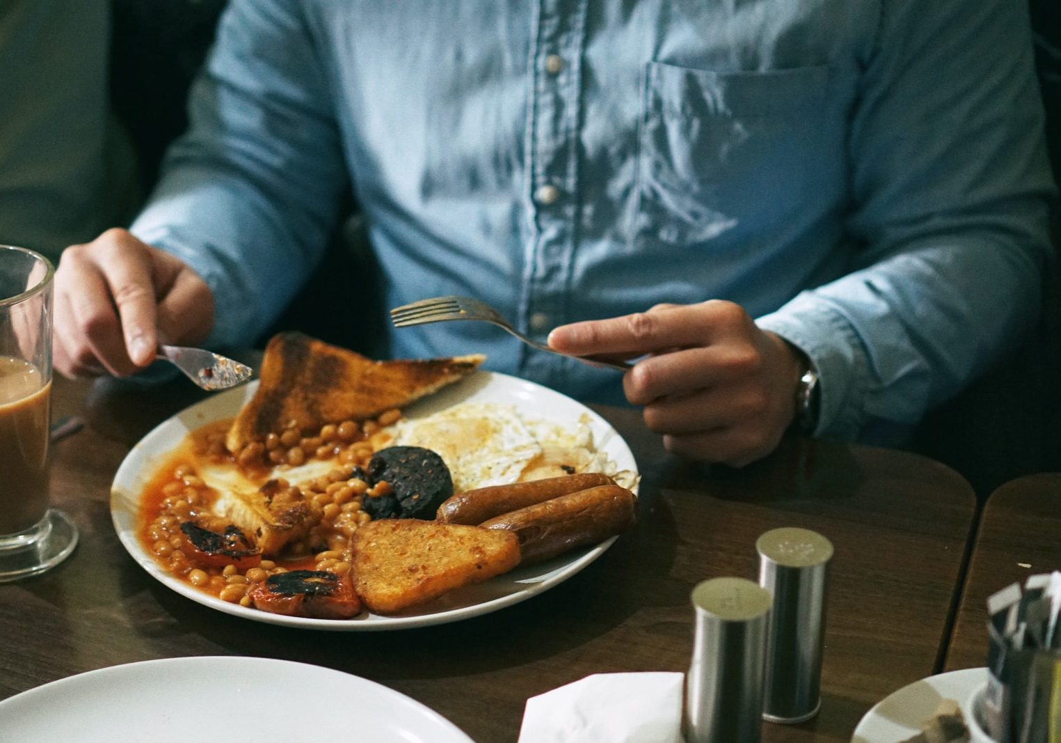 person eating bread with beans